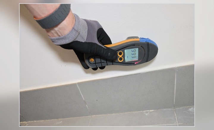Direct moisture reading being collected at a wall